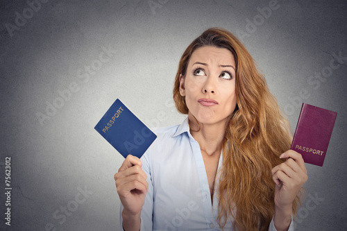 Fotografie woman holding two passports confused face expression