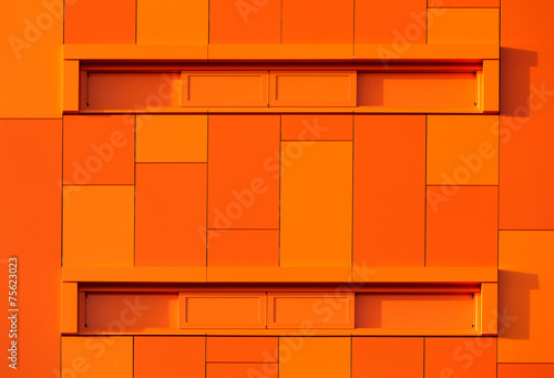 Fotografie Orange wall of a modern apparment building.