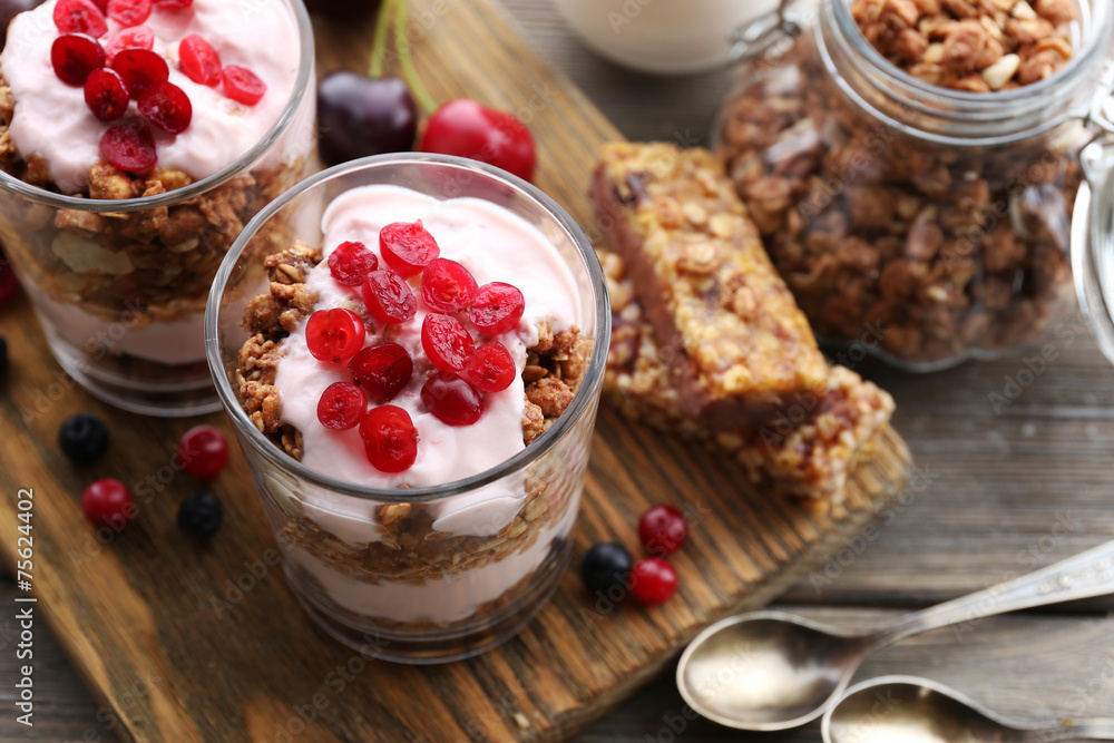 Healthy layered dessert with muesli and berries on table Healthy layered dessert with muesli and berries on table
