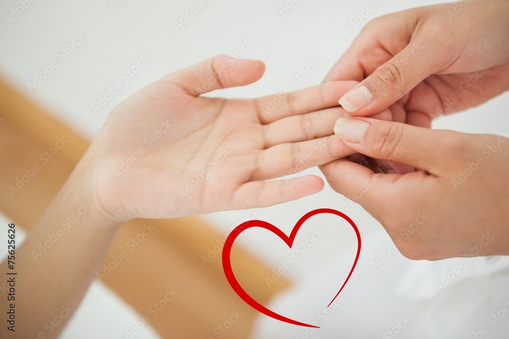 Composite image of woman receiving a hand massage Composite image of woman receiving a hand massage