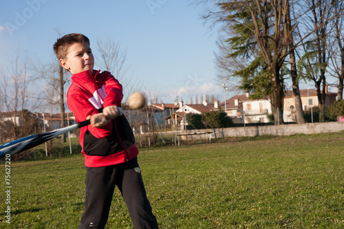 Photography child with red plush that plays baseball