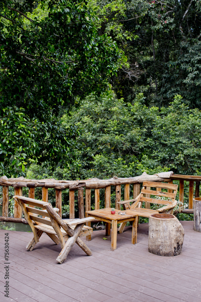 Outdoor bench and view of forest