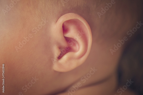 Small delicate little ear of newborn