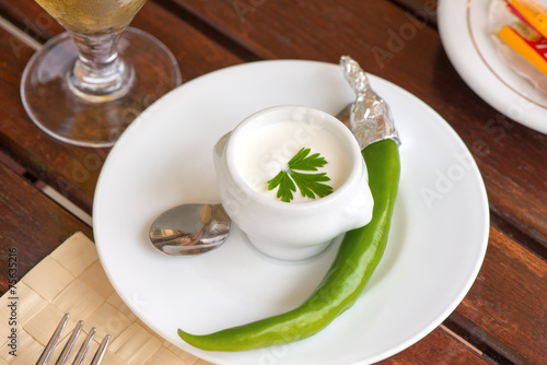 White sauce and green pepper on a plate