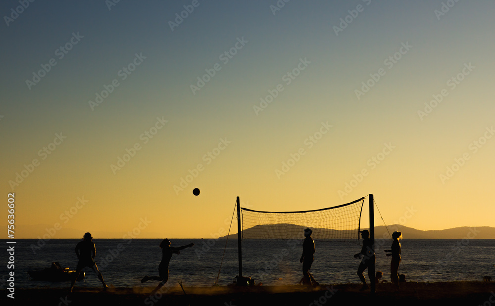 Obraz premium Beach volleyball at sunset.