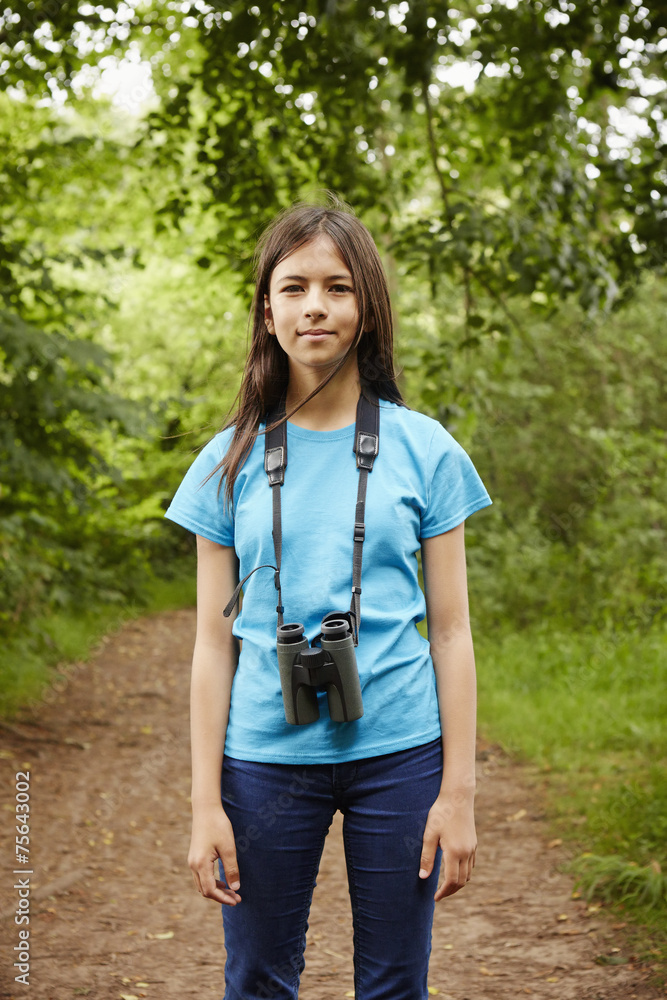 Girl with binoculars standing on footpath Girl with binoculars standing on footpath