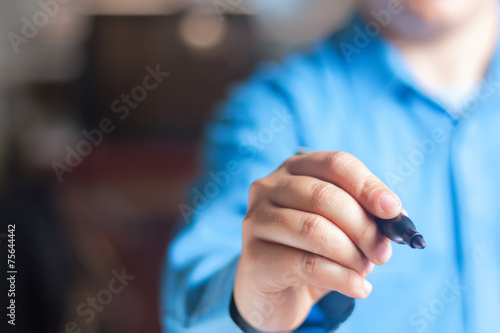 Young man writing on the chalkboard