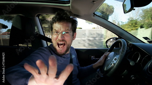 Man shouting into camera while driving pointing finger photo