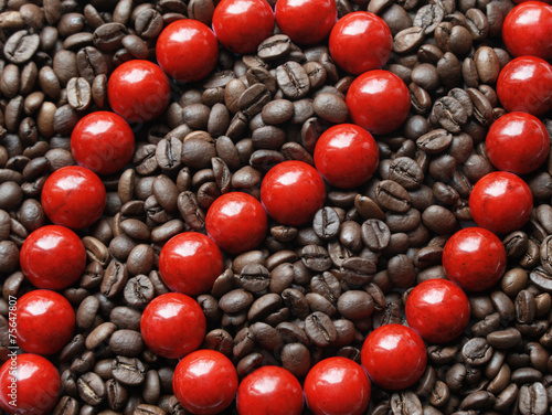 Glossy red beads in brown coffee beans