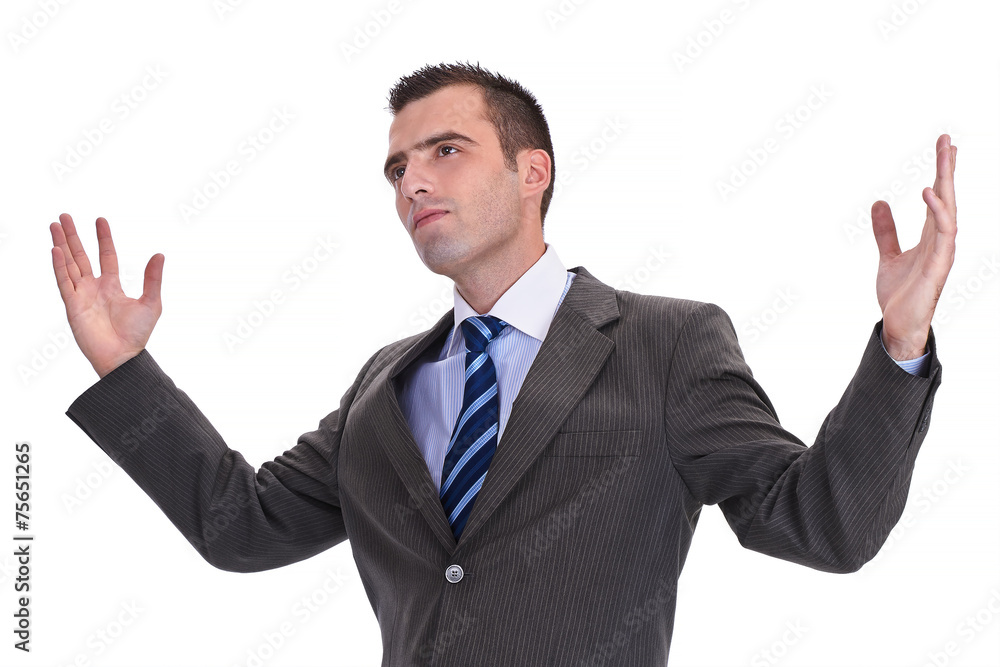 Young businessman in a gray suit with raised hands, looking to Young businessman in a gray suit with raised hands, looking to