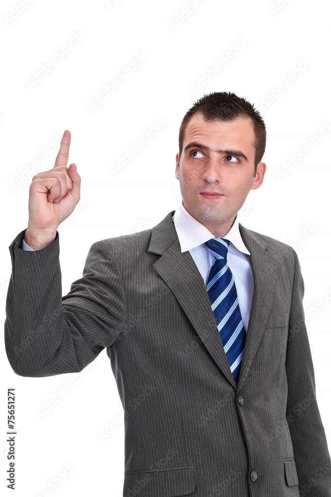 Young businessman in a gray suit pointing and looking up with c Young businessman in a gray suit pointing and looking up with c