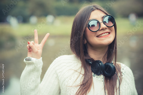 young beautiful brunette woman girl listening music headphones photo