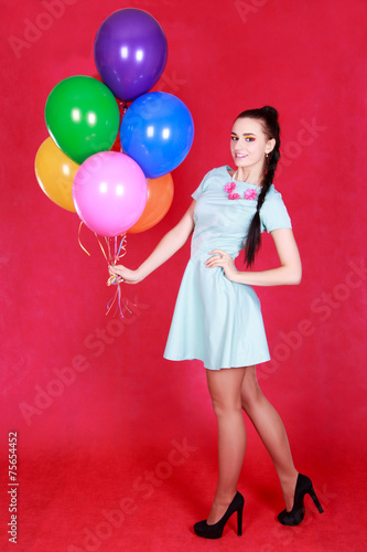 Portrait of a young attractive woman holding bunch of many brigh