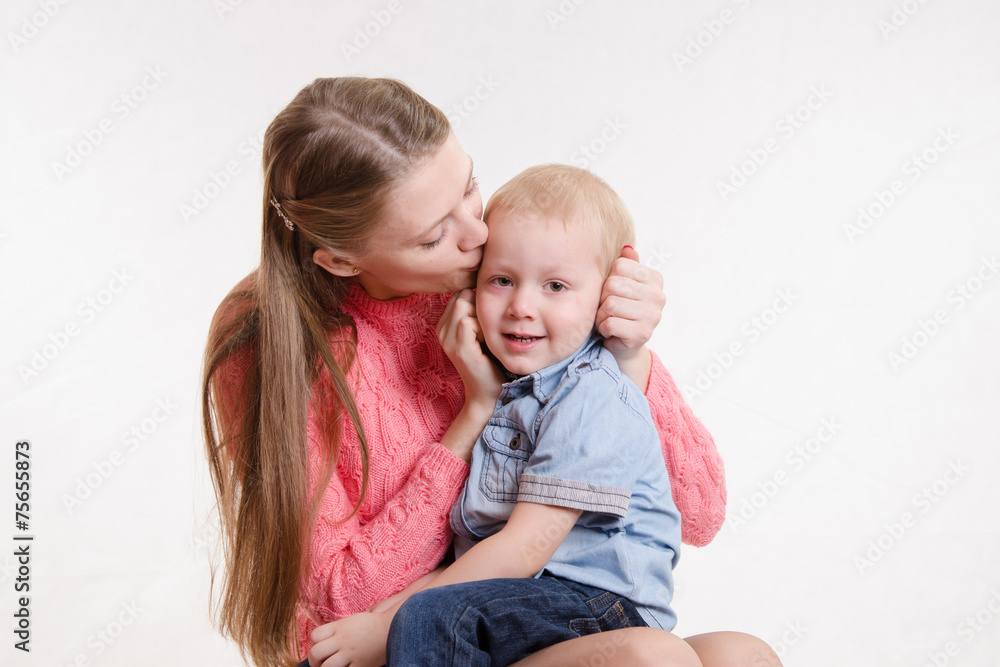 Young mother kissing her son three years Young mother kissing her son three years