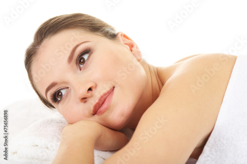 Beautiful young woman having relax in spa salon