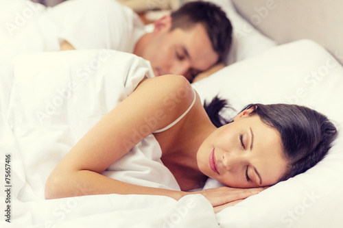 happy couple sleeping in bed