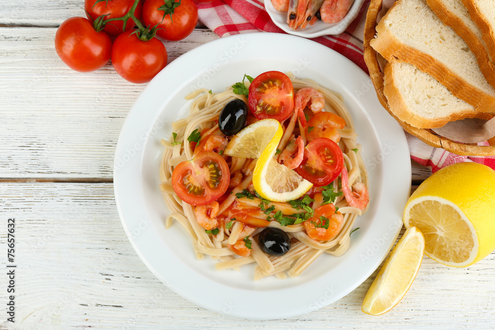 Tasty pasta with shrimps, black olives and tomato sauce Tasty pasta with shrimps, black olives and tomato sauce