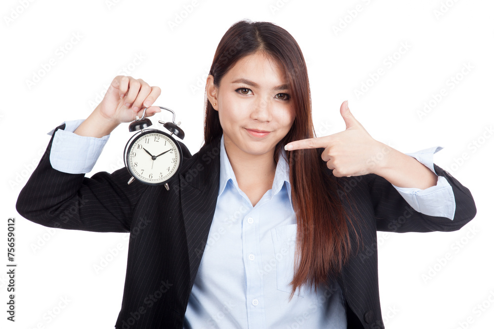 Young Asian businesswoman point to alarm clock Young Asian businesswoman point to alarm clock