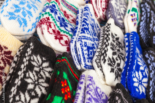 Colorful woolen mittens on the market counter