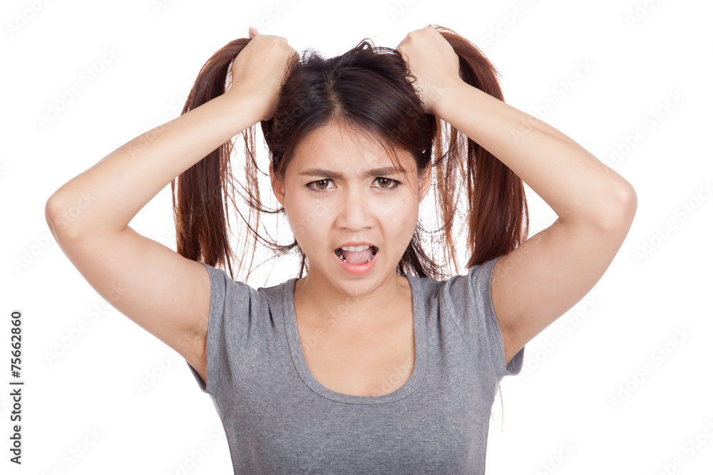Stressed young Asian woman is going crazy pulling her hair Stressed young Asian woman is going crazy pulling her hair