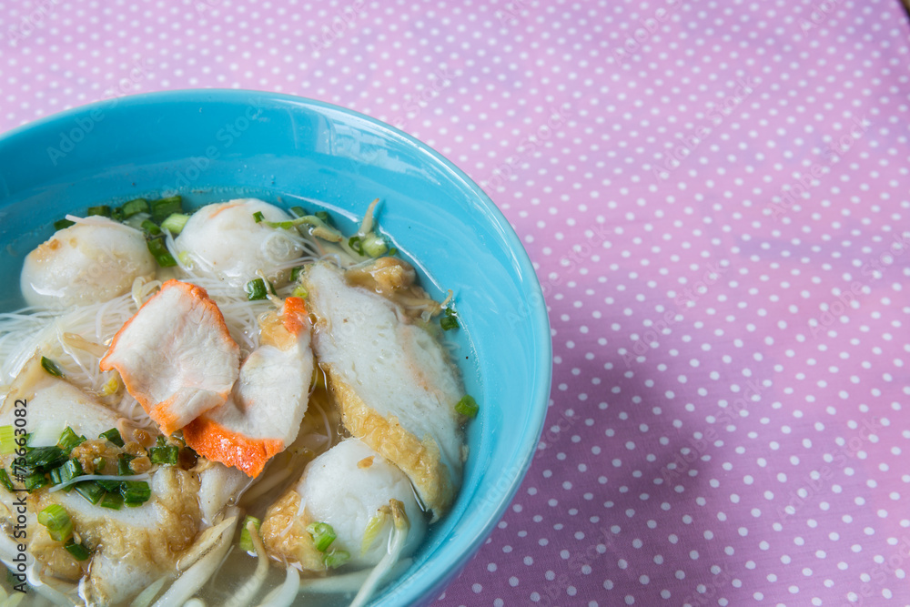 pork rice noodle soup from a bowl on table pork rice noodle soup from a bowl on table