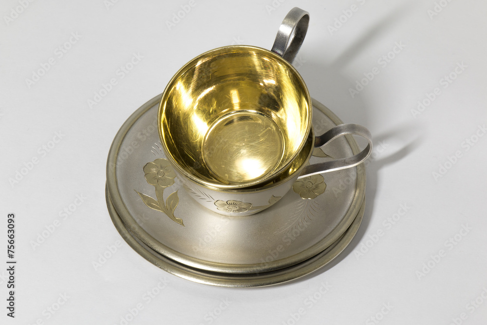 Two metallic saucer and coffee cup in stack Two metallic saucer and coffee cup in stack