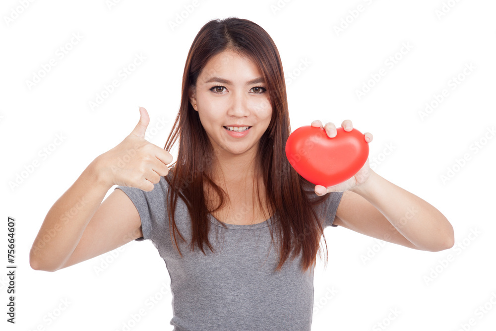 Young Asian woman thumbs up with red heart Young Asian woman thumbs up with red heart