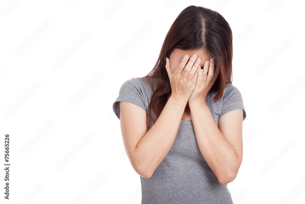 Sad young Asian woman crying with face on palm Sad young Asian woman crying with face on palm