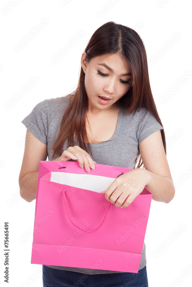 Young Asian woman surprise look inside shopping bag Young Asian woman surprise look inside shopping bag