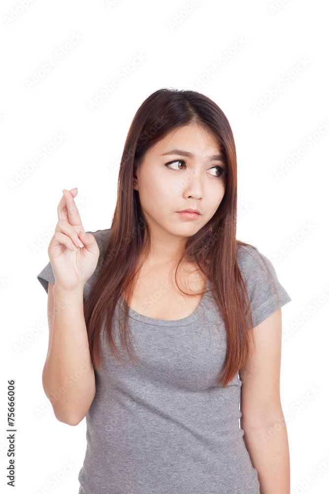 Young Asian woman cross her fingers look away Young Asian woman cross her fingers look away