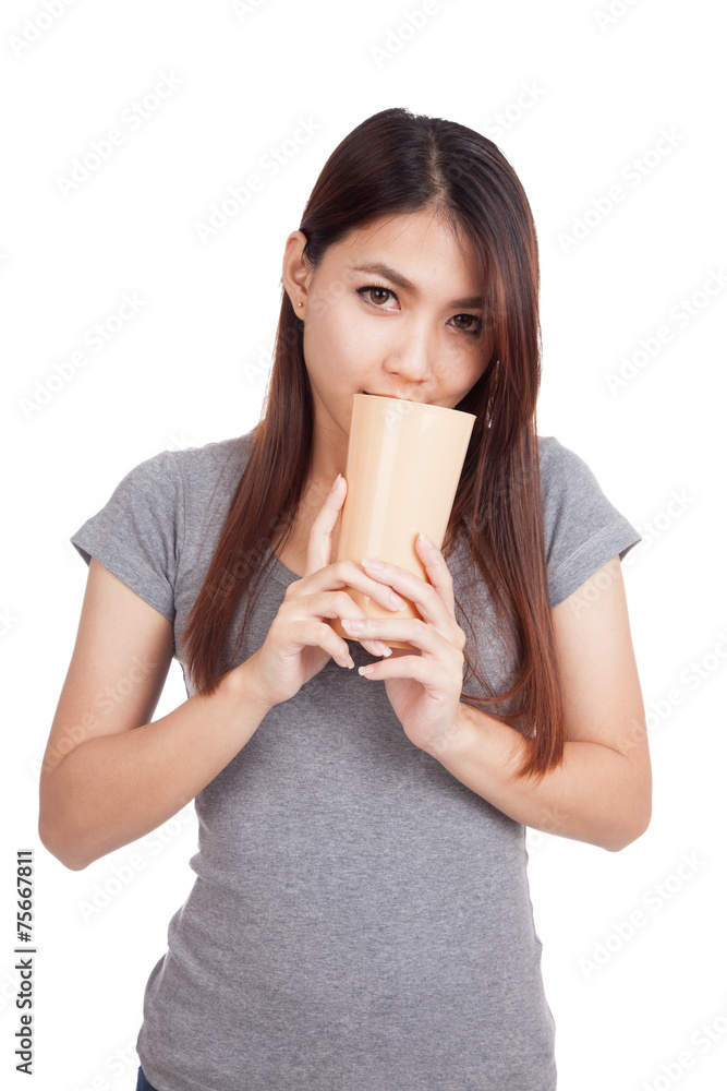 Young Asian woman smell drink in tall plastic glass Young Asian woman smell drink in tall plastic glass