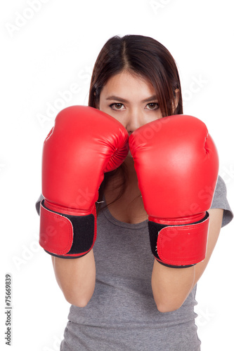 Young Asian woman with red boxing glove © halfbottle