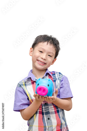 Asain smiling boy with piggy bank isolated on white