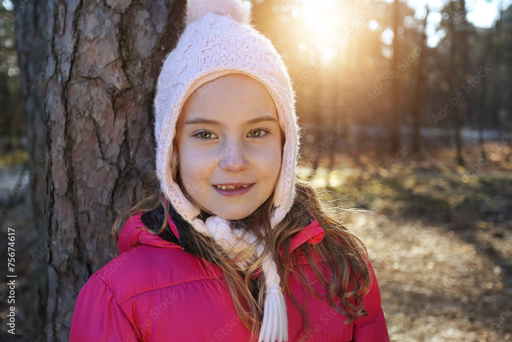 girl in winter cap and jacket outside on a sunny winter day girl in winter cap and jacket outside on a sunny winter day