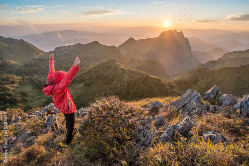 Obraz na plátně Tourist raised his hand with beautiful sunset view on the summit peak of Chiang Dao national park in Chiang Mai province of Thailand