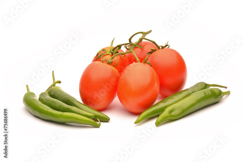 Tomatoes and hot chilli on white background