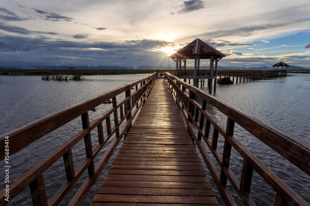 Fototapeta premium The long bridge over the sea with a beautiful sunrise, Thailand