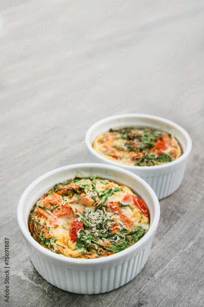 An oven omelette with baby spinach and tomatoes An oven omelette with baby spinach and tomatoes