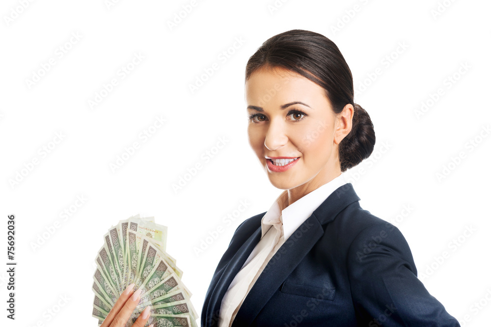 Businesswoman holding a clip of polish money Businesswoman holding a clip of polish money