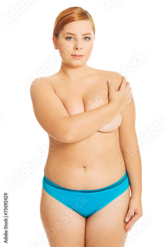 Overweight woman covering her breast