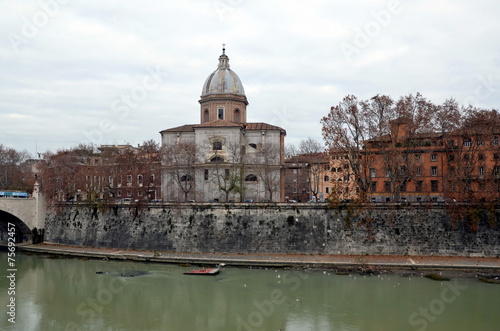 View on Cathedral on the Tiber river on cloudy day. Rome, Italy