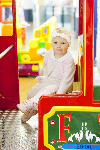 sitting toddler on carousel photo