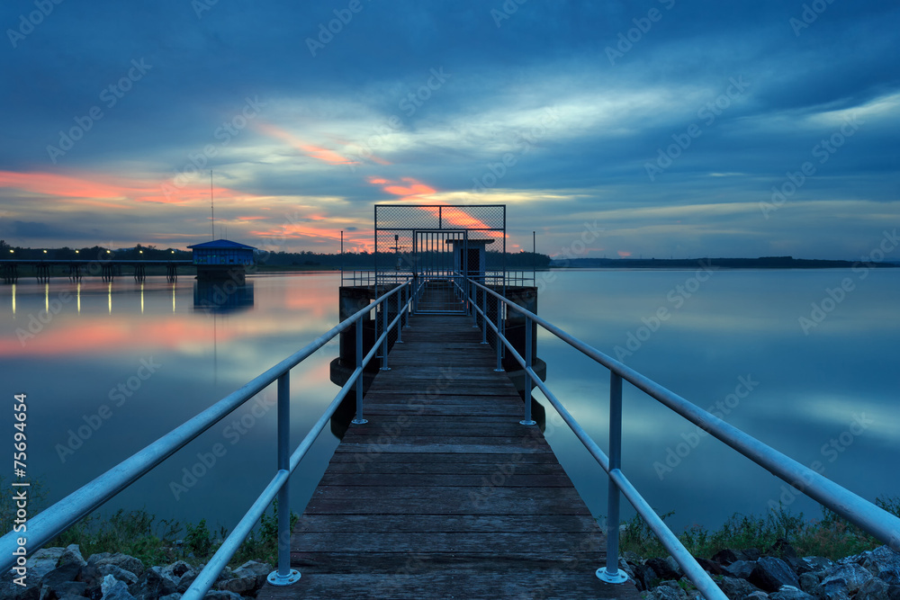 Fototapeta premium The long bridge toward to pump house at reservoir ,Thailand