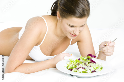 lying down woman eating salad