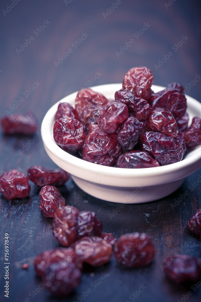 dried cranberries in a wooden spoon. fruit full of vitamin c. dried cranberries in a wooden spoon. fruit full of vitamin c.