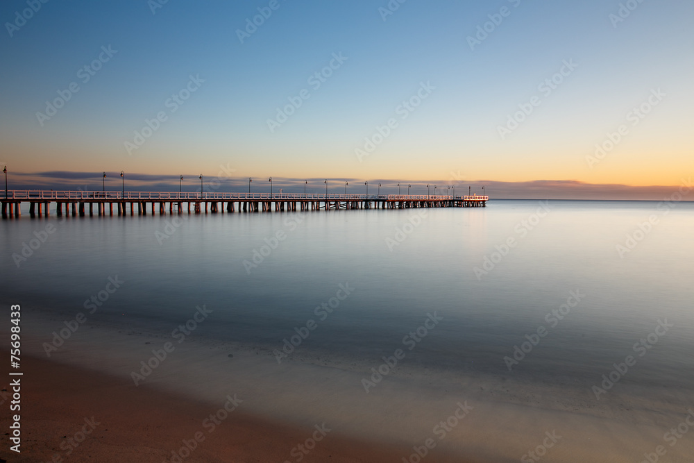 Fototapeta premium Beautiful colorful Sunrise on the pier at the seaside