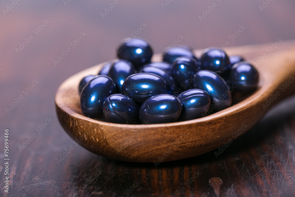 Cod liver oil omega 3 gel capsules isolated on wooden background Cod liver oil omega 3 gel capsules isolated on wooden background