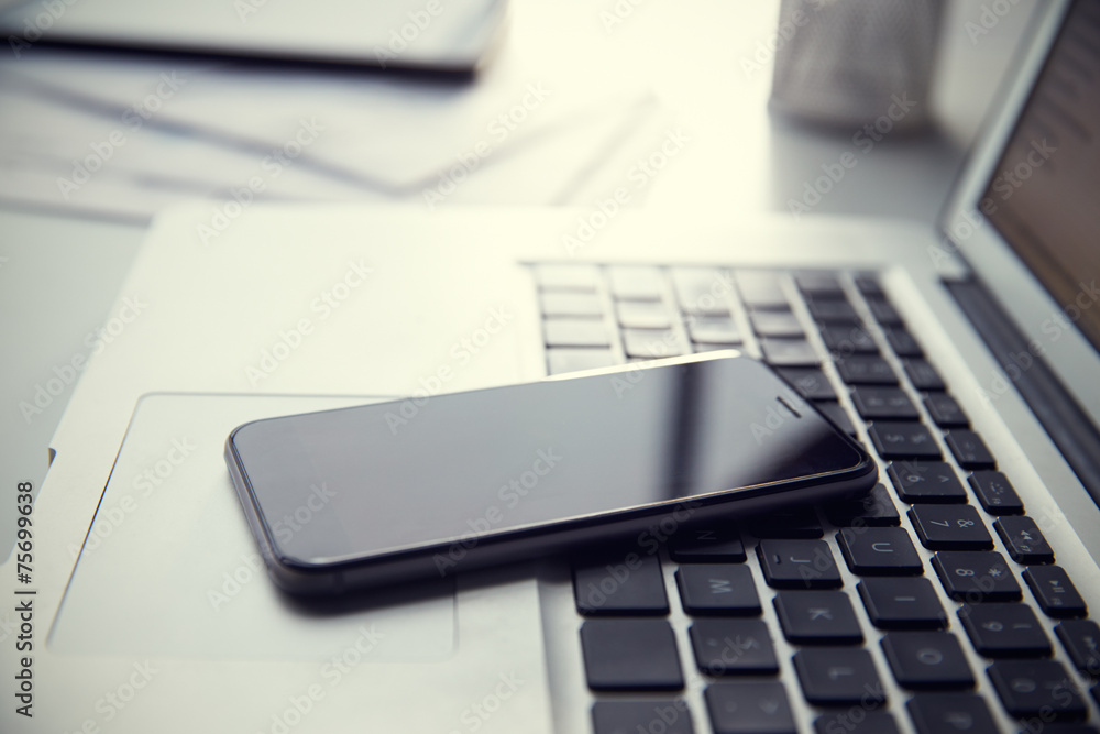 Mobile Phone Resting On Laptop Keyboard Mobile Phone Resting On Laptop Keyboard