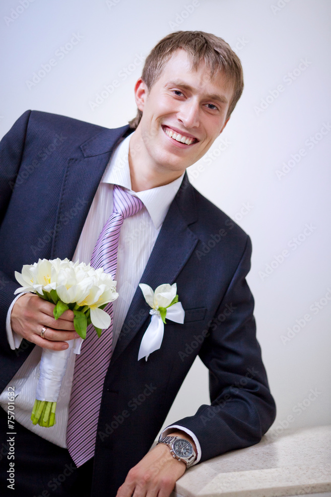 Portrait of the groom with a bouquet of roses Portrait of the groom with a bouquet of roses