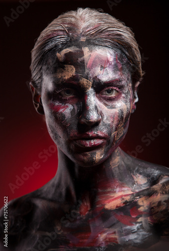 art photo of a beautiful woman with painted face art
